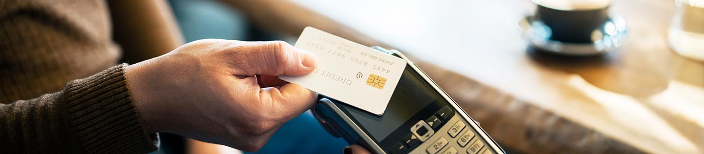 A man using a credit or debit card in a restaurant